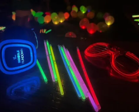 Glow sticks, LED shutter glasses, and a Mobile Rundown headset on a table